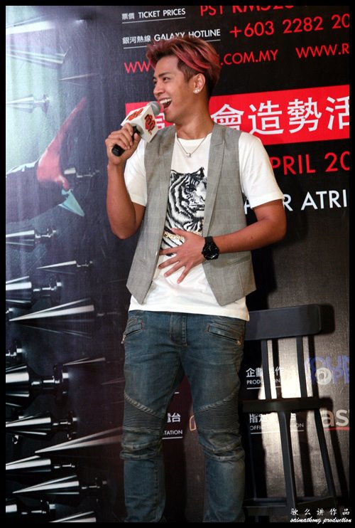 Show poses during a promotional event for his upcoming concert