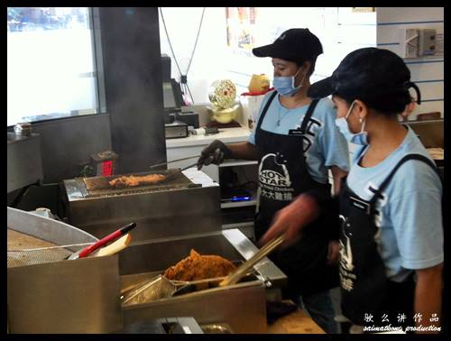 Workers frying chicken @ 