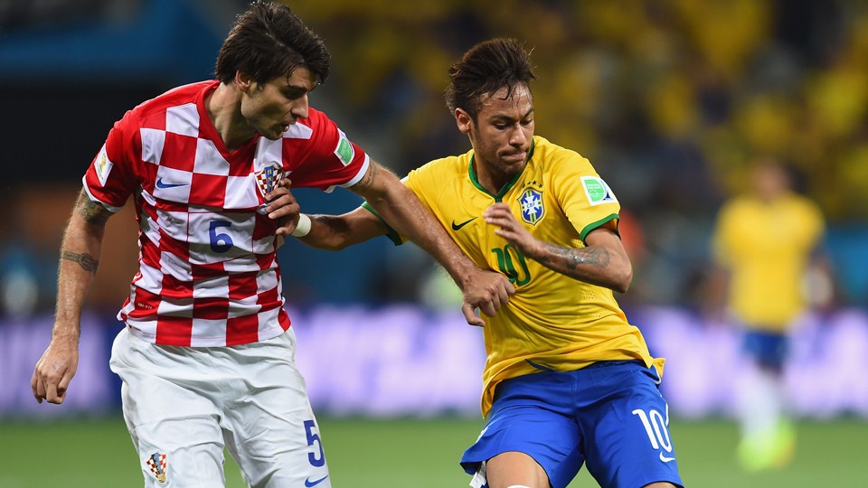 Neymar of Brazil holds off Vedran Corluka of Croatia  (Photo by Buda Mendes/Getty Images)