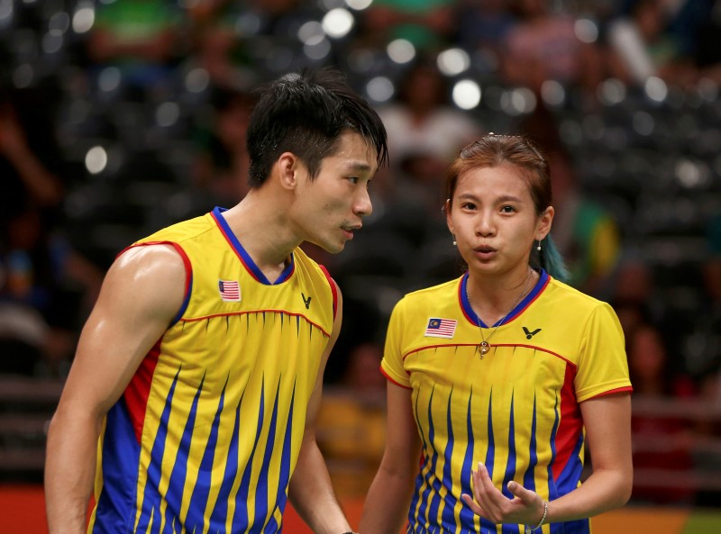 Peng Soon (left) and Liu Ying strategise during the game against the Chiinese pair. - Reuters