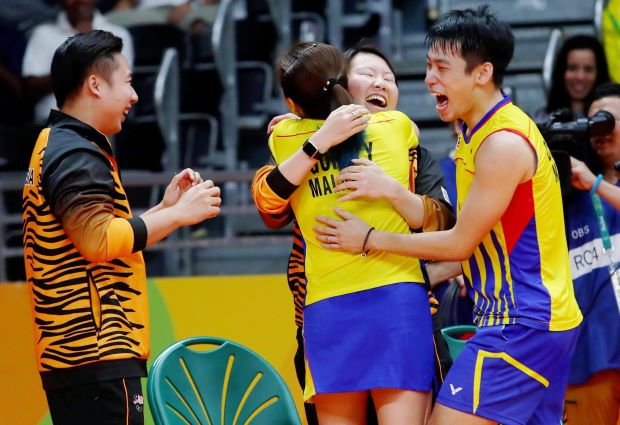 Chan Peng Soon and Goh Liu Ying celebrates with their coaches Jeremy Gan and Chin Eei Hui after winning the mixed doubles semifinal match at the Riocentro in Rio de Janeiro.