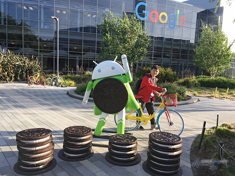 Riding on the colorful bike meant for Googlers (Google employees) to pedal between buildings on the massive campus.
